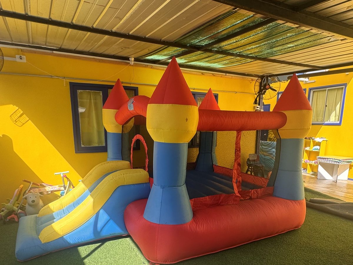 Castillo inflable con resbalín montado en el patio
